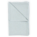 A KraftKids Babydecke Musselin in Grün mit goldenen Punkten und weißer Paspelierung, ordentlich gefaltet mit einer umgeschlagenen Ecke.