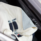 Eine Nahaufnahme der KraftKids Decke für Babyschale Winter Musselin grau Pusteblumen, eine weiche Babydecke mit hellgrauem Innenfutter und Gurtschlitzen, abgebildet auf einem Autositz mit schwarz gepolsterten Gurten zur sicheren Befestigung.