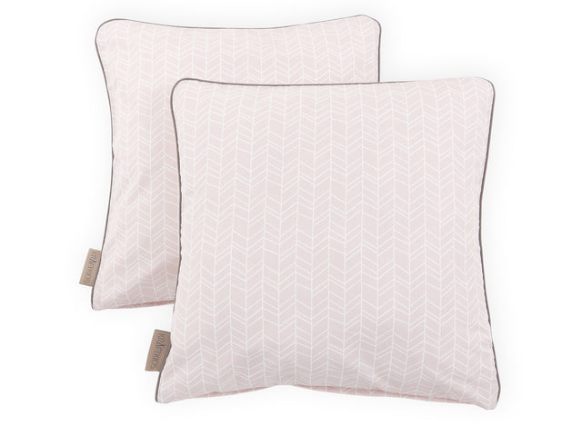 Motivo a piume bianche sulla fodera del cuscino rosa